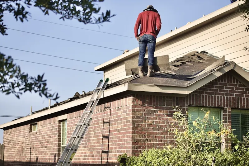 Professional roofer working on a residential roof in Woodlore